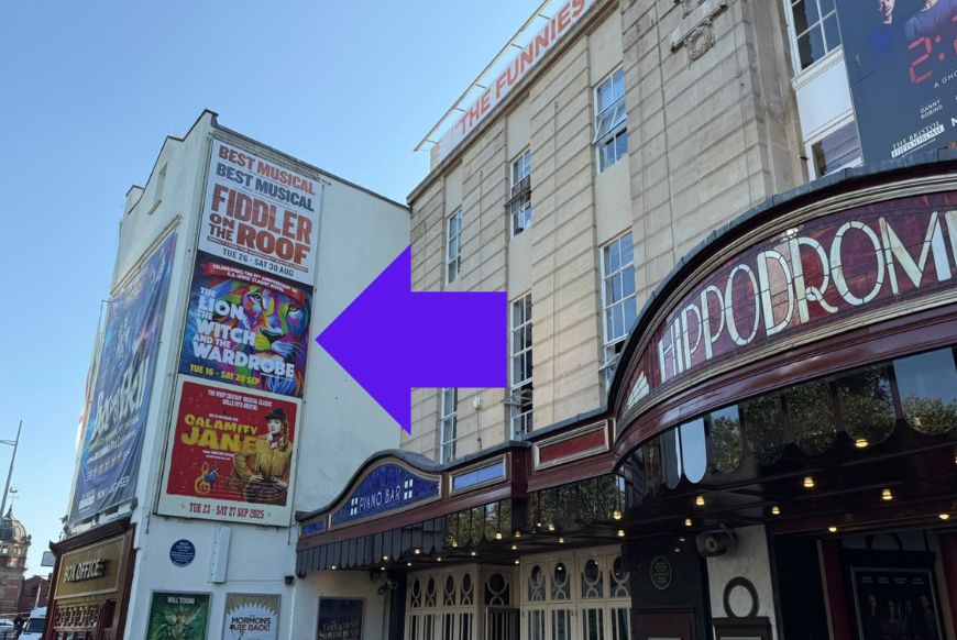 outside of the bristol hipodrome, arrow pointing towards advertisment slots on the side